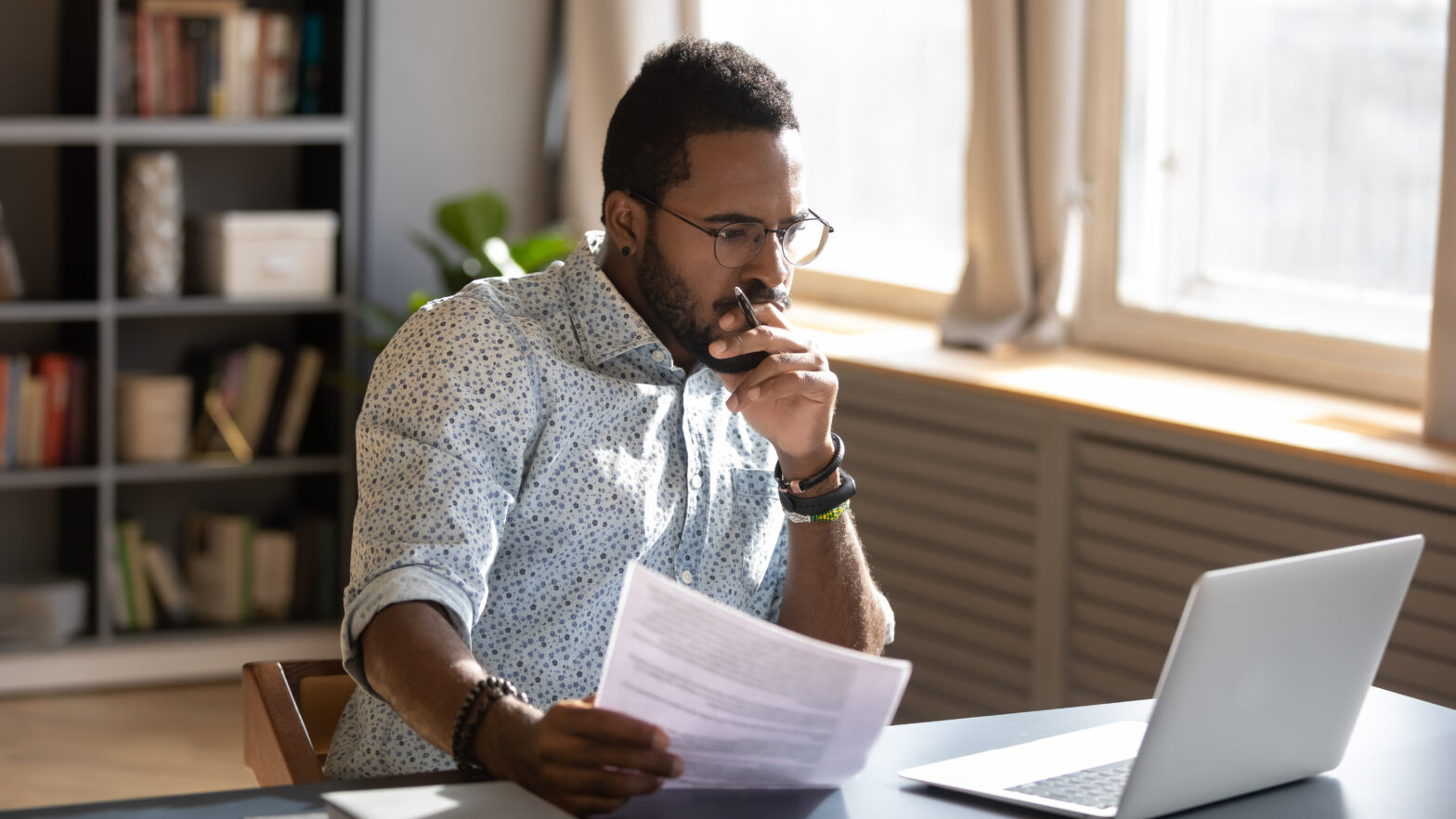 Focused,Serious,African,American,Businessman,Accountant,Analyst,Holding,Documents,Looking